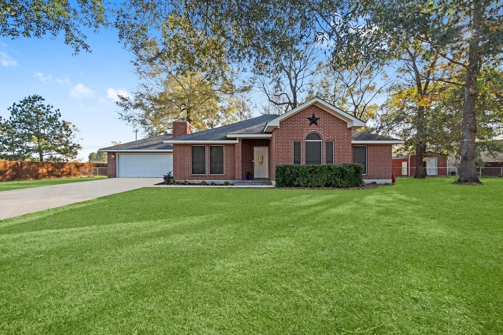 single story home featuring a garage and a front lawn