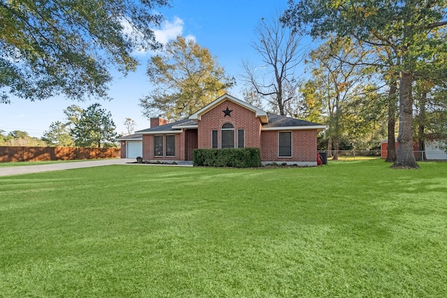 view of front of home featuring a front yard and a garage