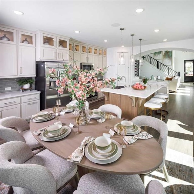 dining space featuring dark hardwood / wood-style flooring and sink