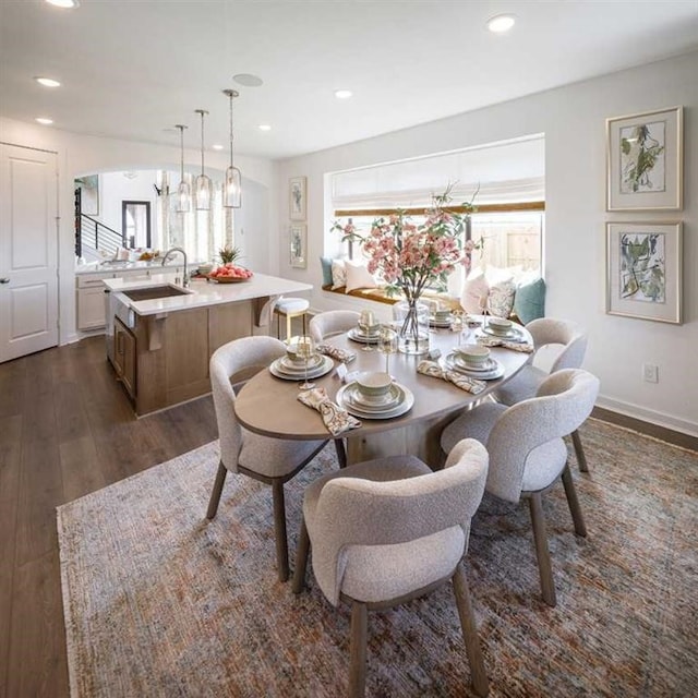 dining area featuring dark wood-type flooring and sink