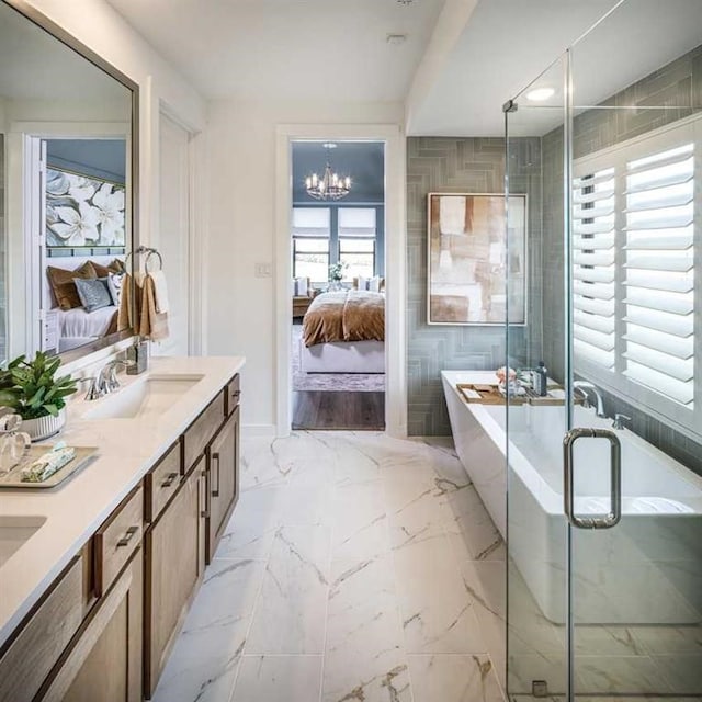 bathroom featuring plus walk in shower, vanity, and a chandelier