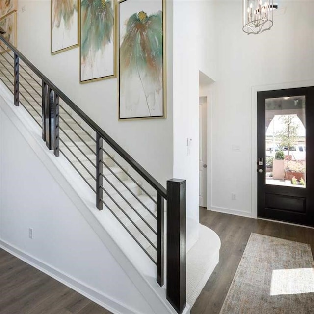 entryway featuring dark hardwood / wood-style floors and an inviting chandelier