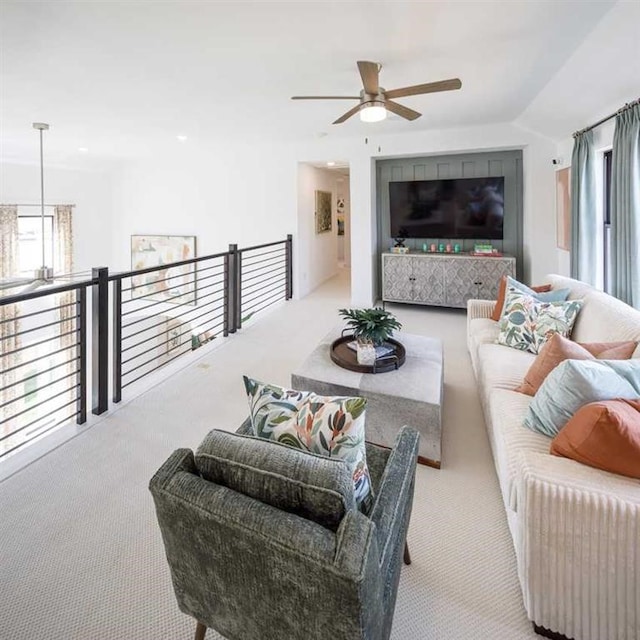 carpeted living room featuring ceiling fan