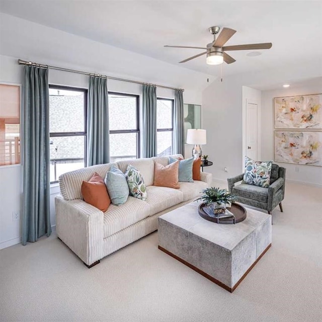 living room featuring carpet, plenty of natural light, and ceiling fan