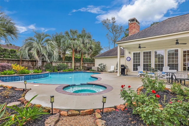 view of pool featuring ceiling fan, an in ground hot tub, and a patio