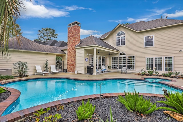 view of pool featuring ceiling fan, a grill, a patio area, and an in ground hot tub