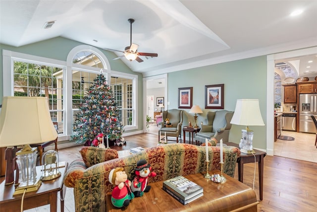 living room featuring light wood-type flooring, vaulted ceiling, and ceiling fan