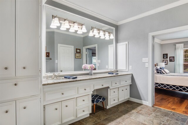 bathroom featuring vanity, hardwood / wood-style flooring, and crown molding