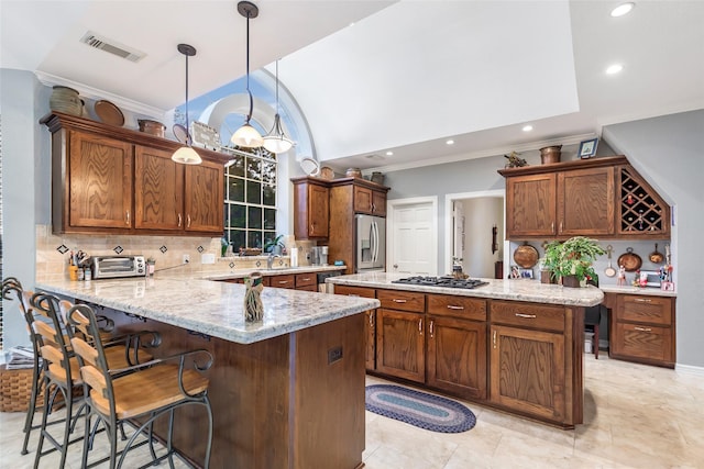 kitchen with decorative backsplash, a kitchen breakfast bar, light stone counters, stainless steel appliances, and pendant lighting