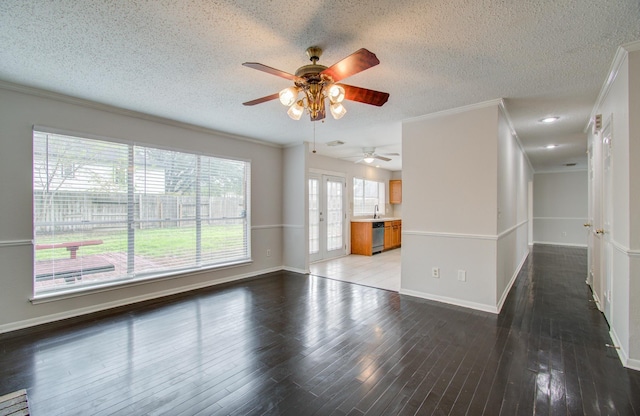 unfurnished living room featuring hardwood / wood-style floors, french doors, ceiling fan, ornamental molding, and a textured ceiling