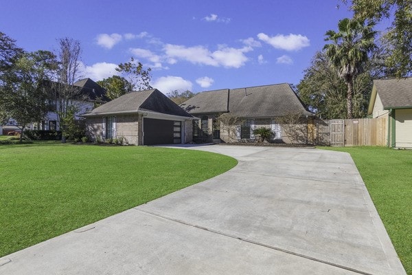 view of front of property featuring a garage and a front lawn