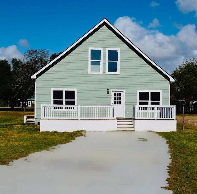 view of side of home with a yard