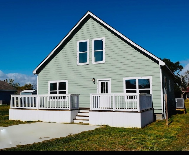 back of property featuring a lawn, a wooden deck, and central AC unit