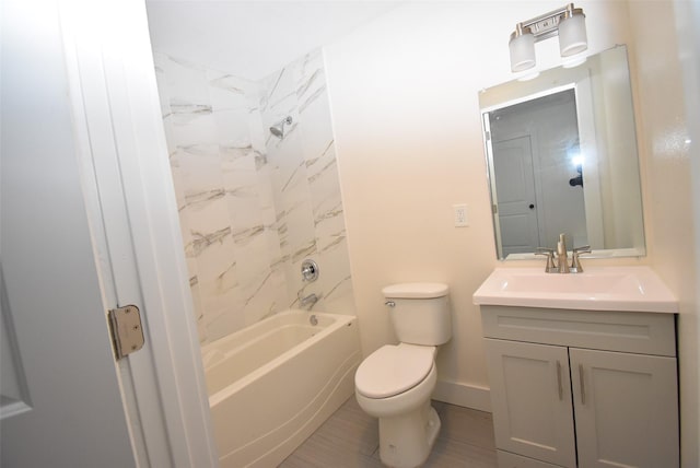 full bathroom featuring tiled shower / bath combo, toilet, and vanity