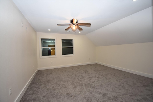 additional living space with ceiling fan, carpet floors, and vaulted ceiling