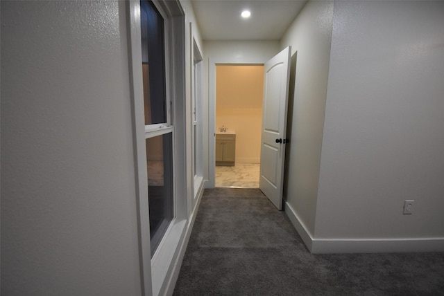 hallway with dark carpet