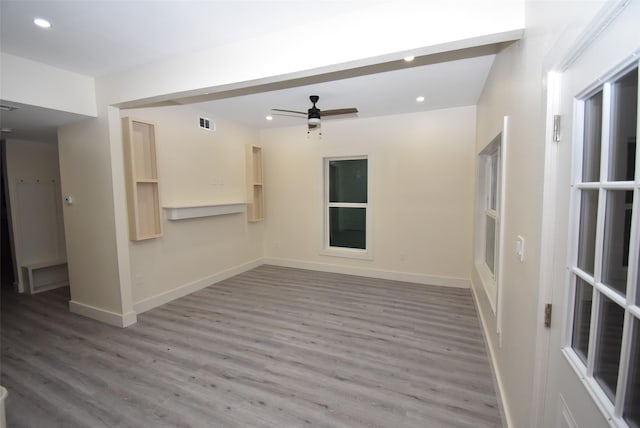 unfurnished living room featuring ceiling fan and wood-type flooring