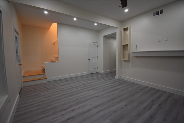 unfurnished living room with ceiling fan and wood-type flooring