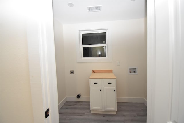 clothes washing area featuring hookup for a washing machine, light hardwood / wood-style flooring, and hookup for an electric dryer