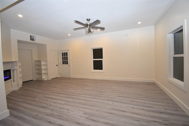 unfurnished living room with light hardwood / wood-style floors and ceiling fan