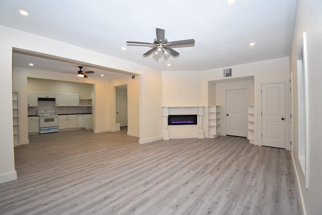 unfurnished living room with light hardwood / wood-style flooring and ceiling fan