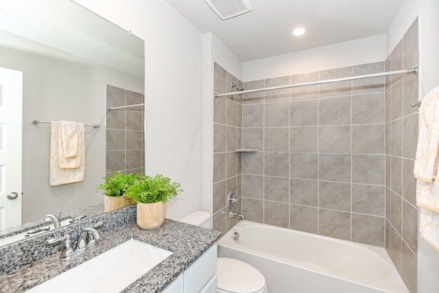 full bathroom with vanity, toilet, and tiled shower / bath