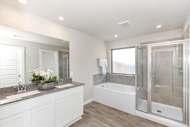 bathroom with vanity, separate shower and tub, and wood-type flooring