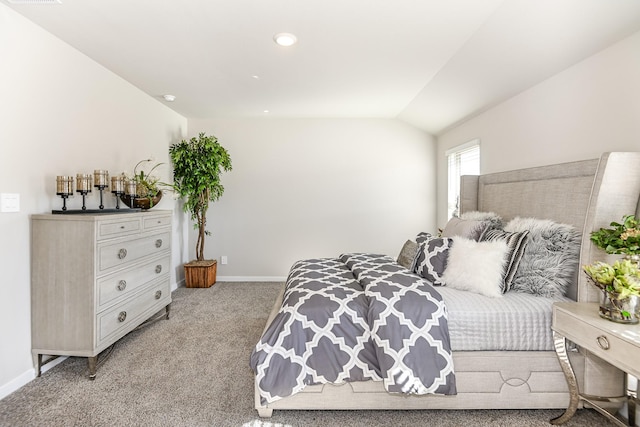 bedroom featuring light carpet and vaulted ceiling