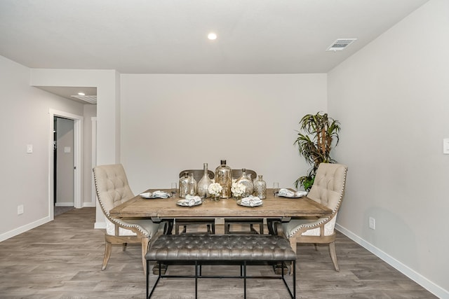 dining space with wood-type flooring