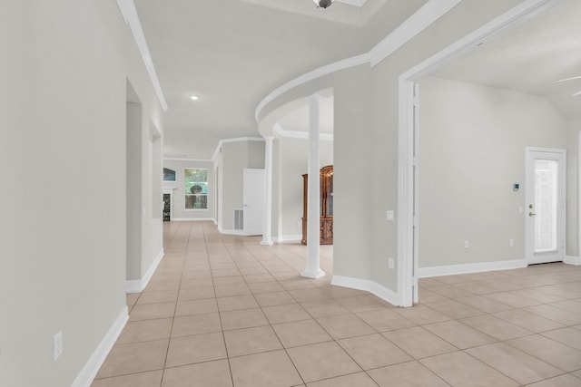 tiled foyer featuring ornate columns and crown molding