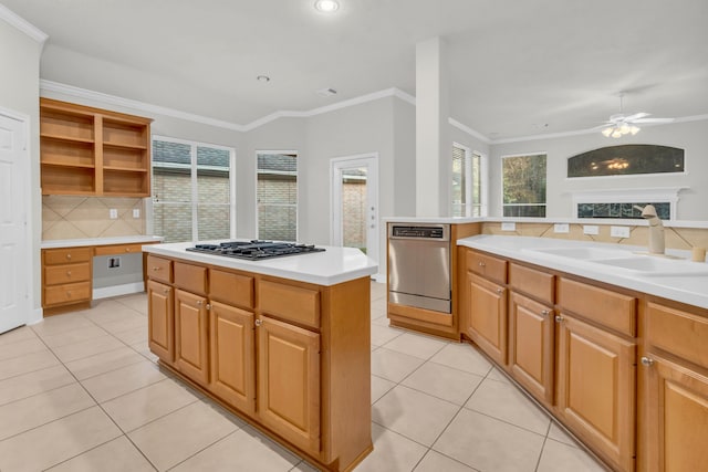 kitchen with sink, a center island, stainless steel appliances, and plenty of natural light