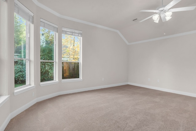 carpeted spare room featuring vaulted ceiling, plenty of natural light, and crown molding