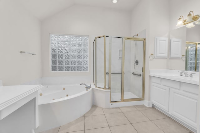 bathroom featuring shower with separate bathtub, vanity, vaulted ceiling, and tile patterned floors