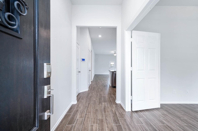 hallway with hardwood / wood-style floors