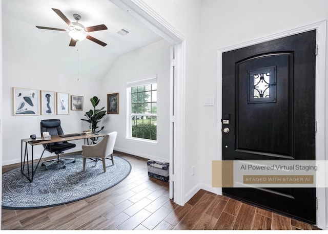 foyer with ceiling fan, wood-type flooring, and vaulted ceiling