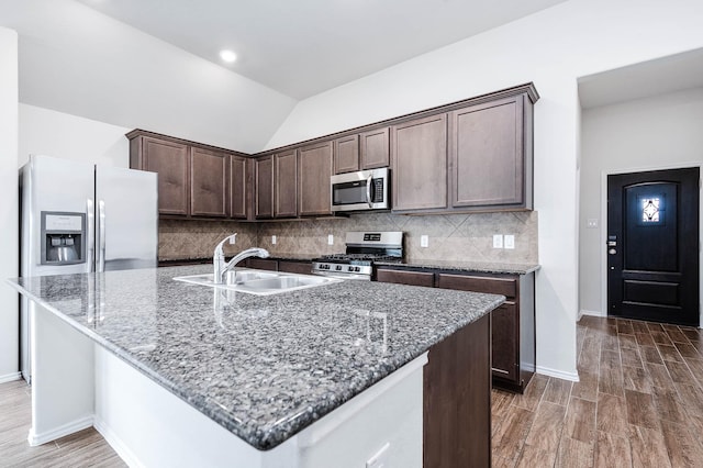 kitchen with backsplash, stainless steel appliances, sink, dark hardwood / wood-style floors, and lofted ceiling