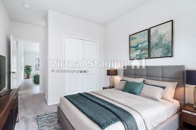 bedroom featuring light carpet and a closet