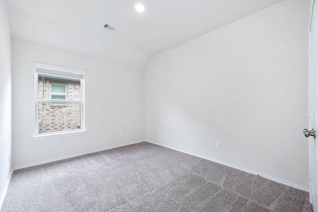 empty room with carpet and lofted ceiling