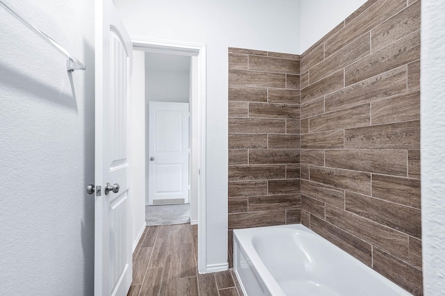 bathroom with shower / bath combination and hardwood / wood-style flooring