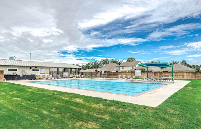 view of swimming pool with a patio area and a yard