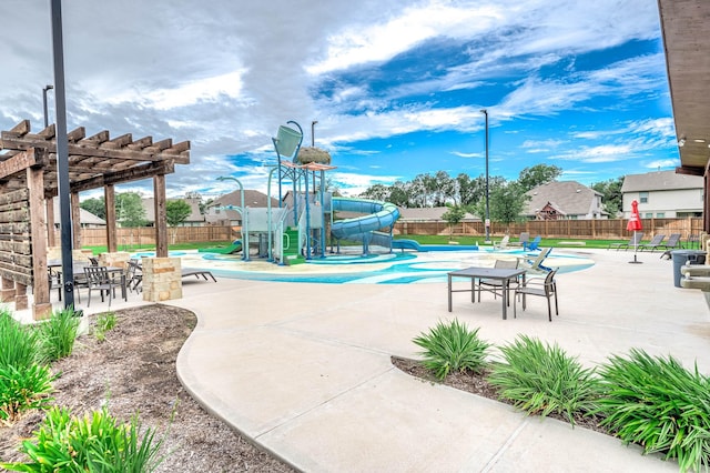 view of playground with a pergola and a fenced in pool