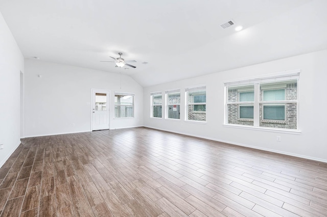 unfurnished living room with hardwood / wood-style floors, vaulted ceiling, and ceiling fan