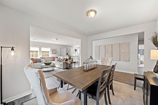 dining space with hardwood / wood-style flooring