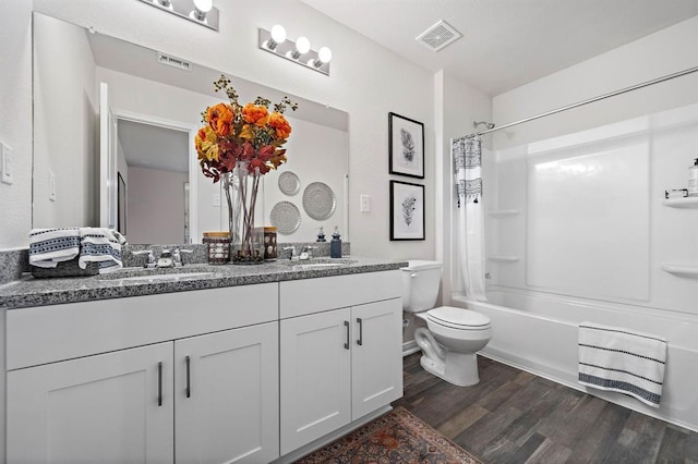 full bathroom featuring shower / tub combo, vanity, hardwood / wood-style flooring, and toilet