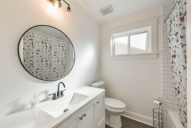 full bathroom featuring hardwood / wood-style floors, vanity, toilet, and tub / shower combination