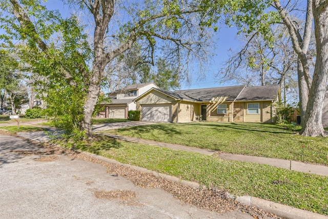 view of front of property with a front yard and a garage