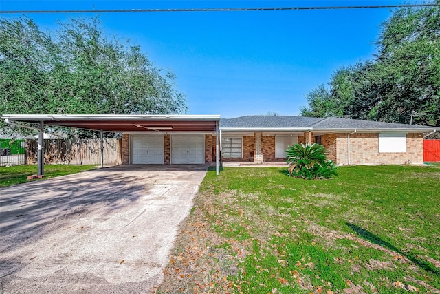 single story home with a carport, a garage, and a front lawn