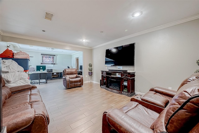 living room with ornamental molding and light wood-type flooring