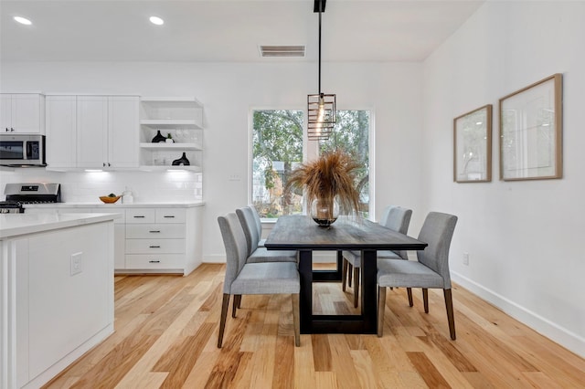 dining space with light hardwood / wood-style floors