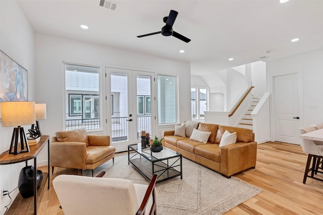 living room with light hardwood / wood-style flooring and ceiling fan